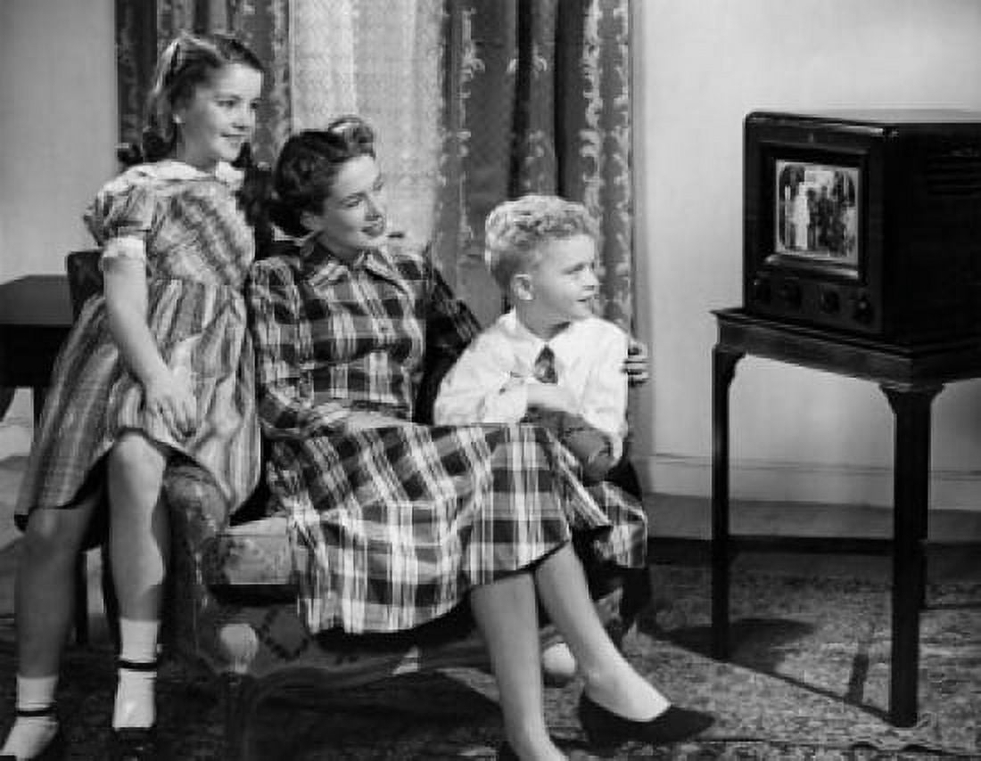 Mid adult woman with son and daughter watching television Canvas Art -  (18 x 24)