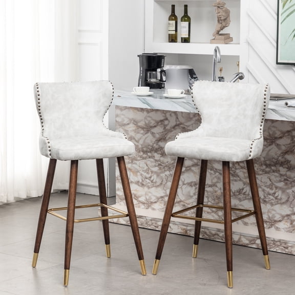 Mid-century Modern 2. Faux Leather With Nailhead Trim. Suede-like Fabric Upholstery. Button Back. Curved Seat. Tapered Walnut Solid Wood Legs. Gold Metal Footrest. 20.42"w X 21.5"d 40.78"h. Seat: