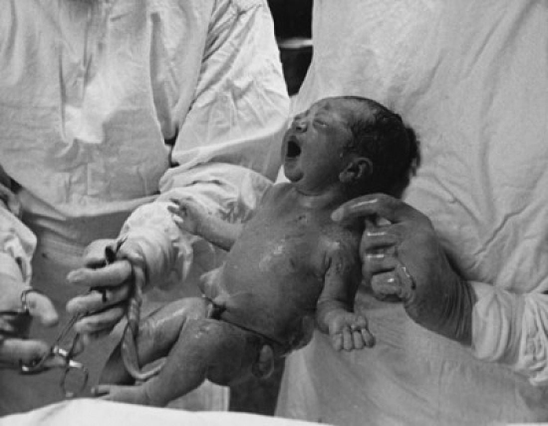 Mid section view of a doctor holding a newborn baby Canvas Art - (18 x 24)