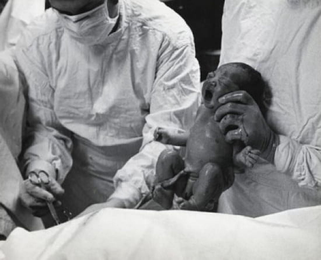 Mid section view of a doctor holding a newborn baby Canvas Art - (24 x 36)