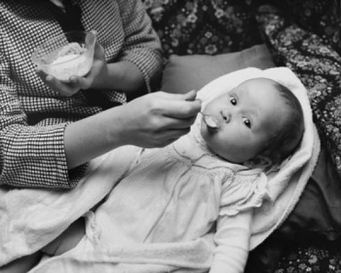 Mid section view of a woman feeding her daughter Canvas Art - (24 x 36)
