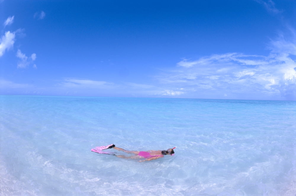 Midway Atoll Woman Snorkels In Shallow Turquoise Water Blue Skies With Wispy Clouds Canvas Art - Ed Robinson Design Pics (19 x 12)
