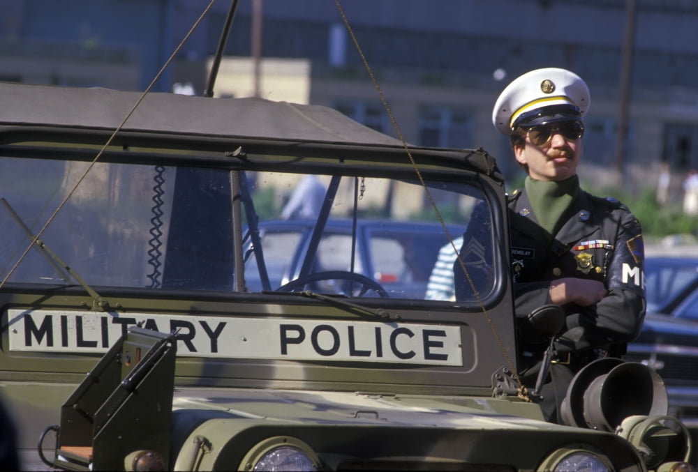 Military Policeman stands next to his jeep while on duty Canvas Art - Michael WoodStocktrek Images (35 x 24)