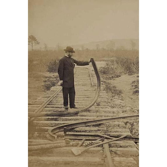 Military railroad operations in northern Virginia: man standing on railroad tracks holding twisted rail Poster Print by unknown (24 x 36)