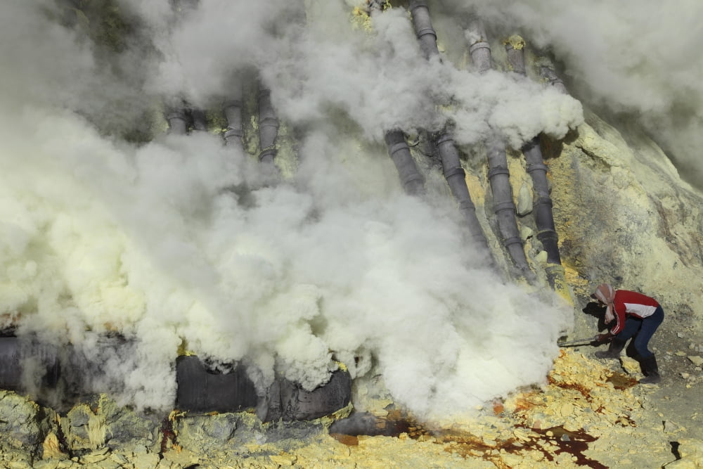 Miner breaking up sulphur deposits at Kawah Ijen Volcano Java Indonesia Canvas Art - Richard RoscoeStocktrek Images (18 x 12)
