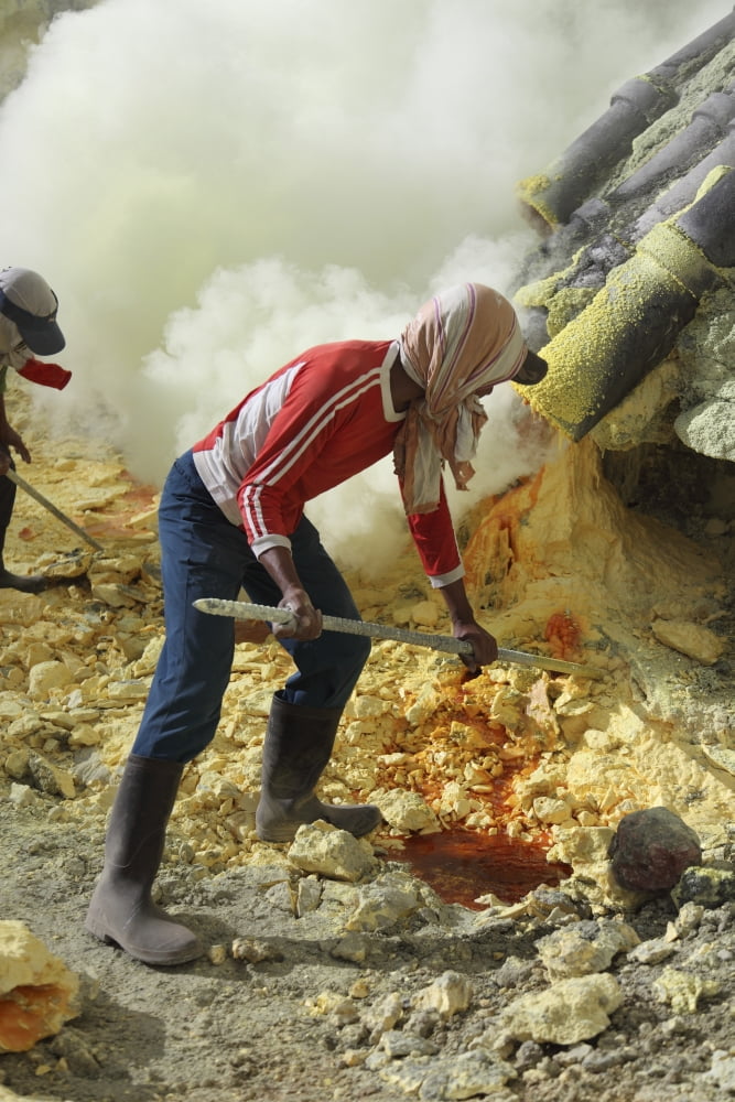 Miner breaking up sulphur deposits at Kawah Ijen Volcano Java Indonesia Canvas Art - Richard RoscoeStocktrek Images (23 x 35)