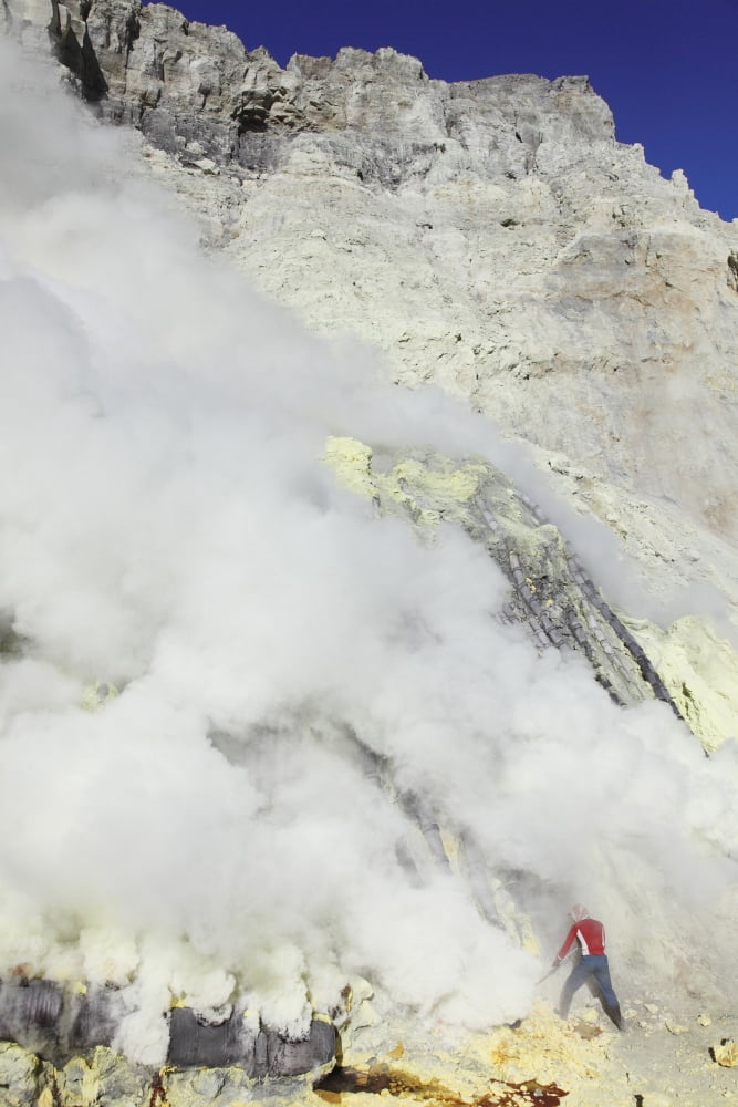 Miner breaking up sulphur deposits at Kawah Ijen Volcano Java Indonesia Canvas Art - Richard RoscoeStocktrek Images (24 x 35)