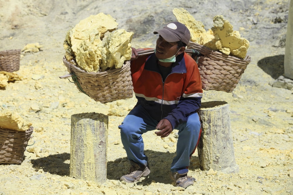 Miner lifting heavy baskets full of sulphur Kawah Ijen volcano Java Indonesia Canvas Art - Richard RoscoeStocktrek Images (35 x 23)