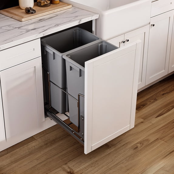 Dual compartment pull-out recycling bin installed in a kitchen cabinet