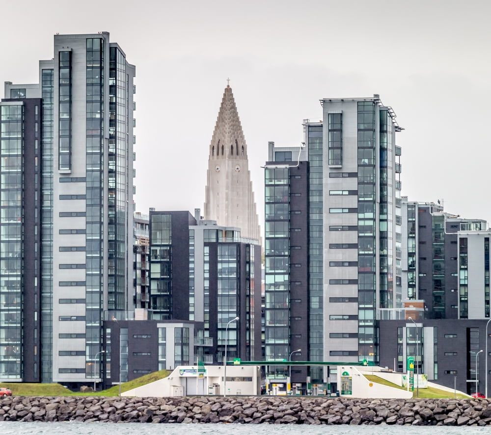 Modern apartment buildings surrounding Hallgrimskirkja Church Reykjavik Iceland Canvas Art - Panoramic Images (24 x 24)