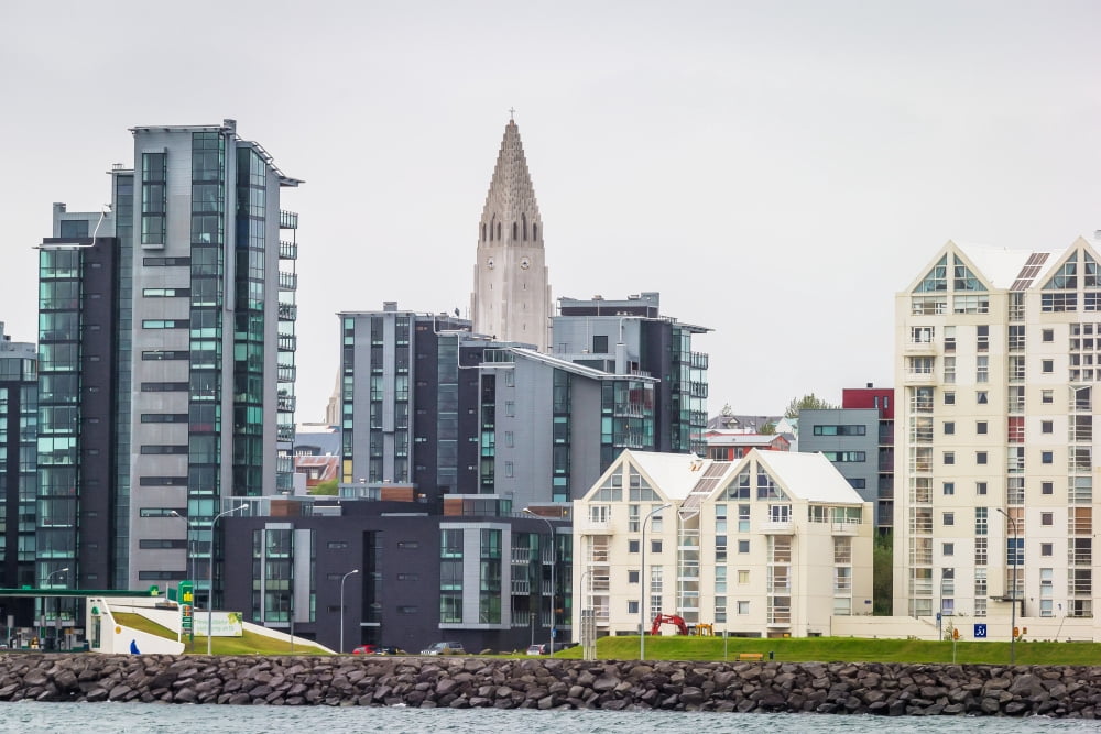 Modern apartment buildings surrounding Hallgrimskirkja Church Reykjavik Iceland Canvas Art - Panoramic Images (27 x 9)