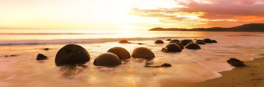 Moeraki Boulders on the beach at sunrise Moeraki Otago Region South Island New Zealand Canvas Art - Panoramic Images (27 x 9)