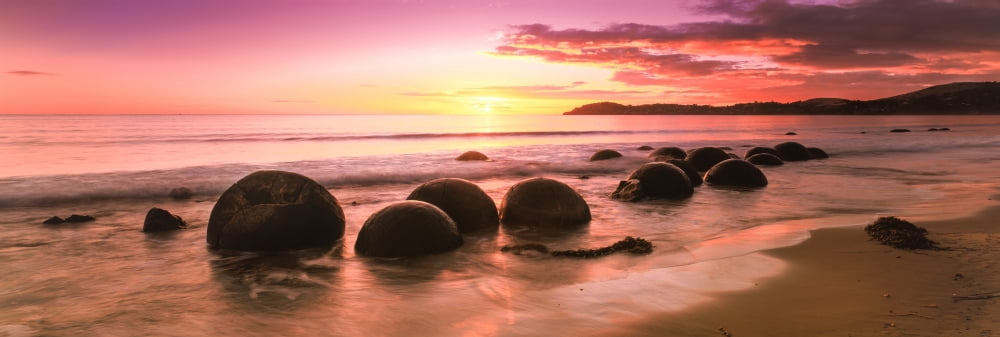 Moeraki Boulders on the beach at sunrise Moeraki Otago Region South Island New Zealand Canvas Art - Panoramic Images (27 x 9)