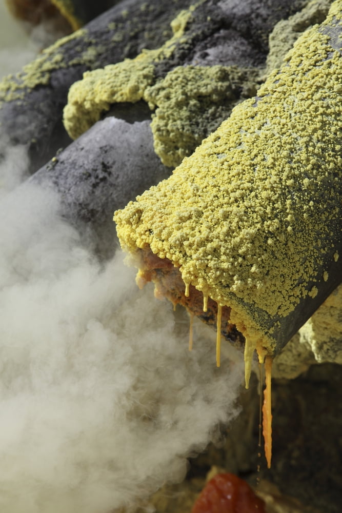 Molten sulphur trickling out of condensation pipe Kawah Ijen volcano Java Indonesia Canvas Art - Richard RoscoeStocktrek Images (23 x 35)