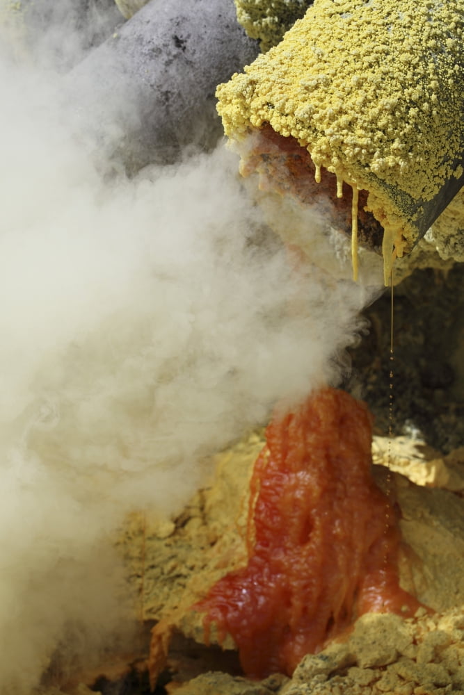Molten sulphur trickling out of condensation pipe Kawah Ijen volcano Java Indonesia Canvas Art - Richard RoscoeStocktrek Images (23 x 35)