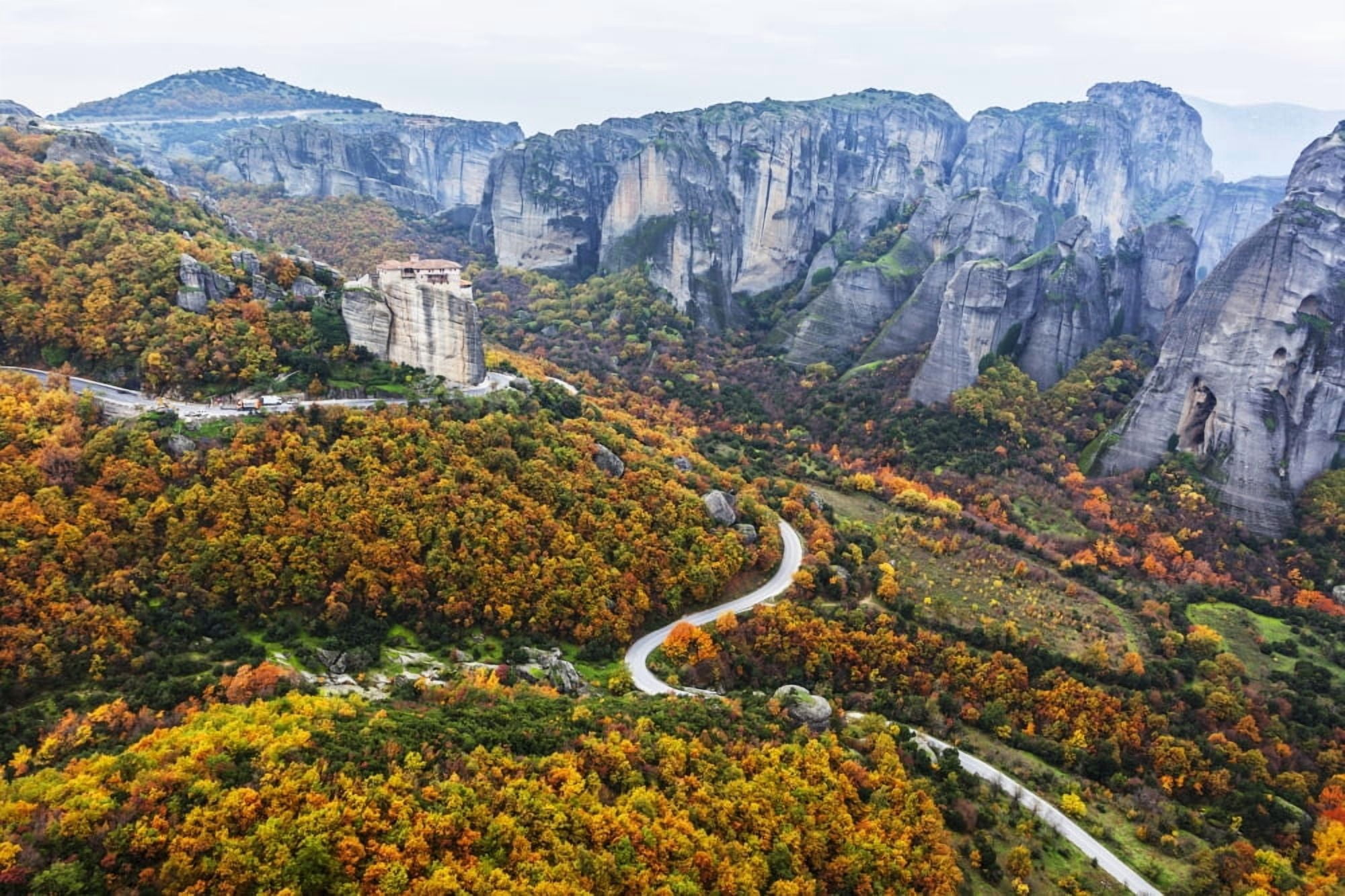 Monastery perched on a cliff with autumn coloured foliage Meteora Greece Stretched Canvas - Reynold Mainse Design Pics (38 x 24)