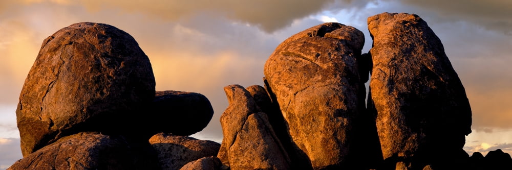 Monolithic boulders glow at sunset Joshua Tree National Park California USA Canvas Art - Panoramic Images (27 x 9)