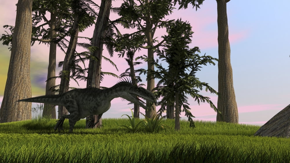 Monolophosaurus running across a grassy field Canvas Art - Kostyantyn IvanyshenStocktrek Images (19 x 11)