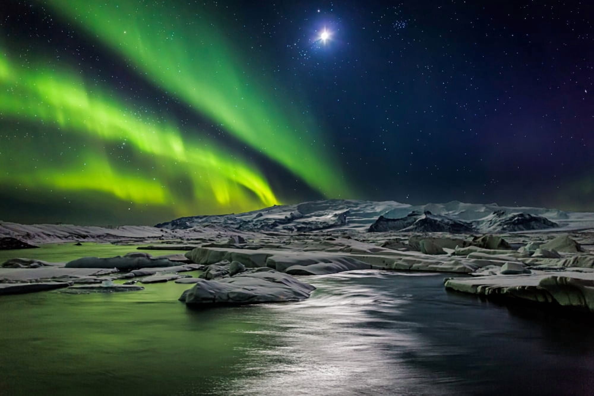 Moon and Aurora Borealis Northern lights with the moon illuminating the skies and icebergs at the Jokulsarlon Glacial lagoon Iceland Canvas Art - Panoramic Images (36 x 12)