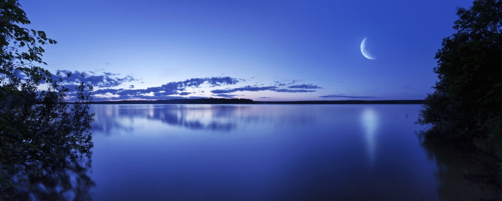 Moon rising over tranquil lake against moody sky Mozhaisk Russia Canvas Art - Evgeny KuklevStocktrek Images (23 x 9)