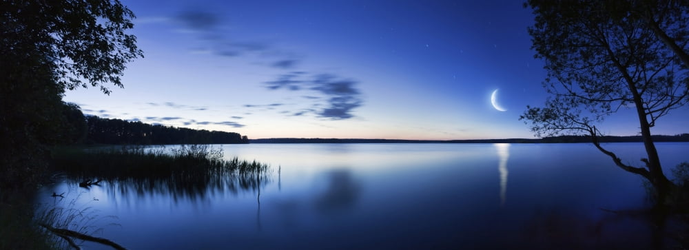 Moon rising over tranquil lake against moody sky Mozhaisk Russia Canvas Art - Evgeny KuklevStocktrek Images (47 x 17)