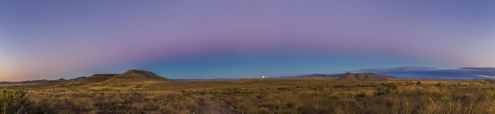 Moonrise at the City of Rocks State Park with Belt of Venus lighting the upper atmosphere Canvas Art - Alan DyerStocktrek Images (58 x 14)