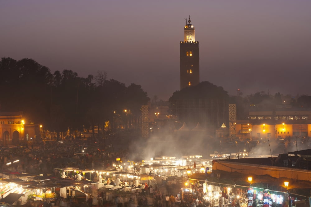 Morocco Looking across food stalls in Dejmaa el Fna at dusk with minaret of Koutoubia mosque behind Marrakesh Canvas Art - Ian Cumming Design Pics (38 x 24)