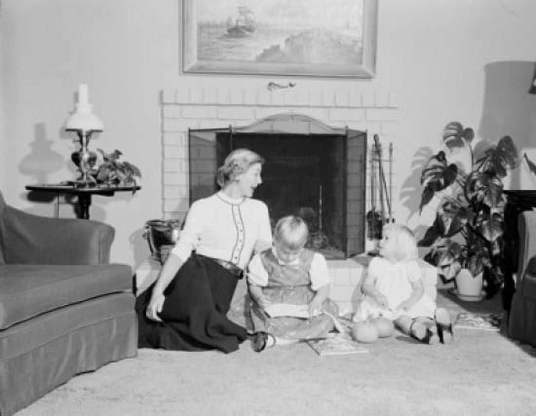 Mothe with son and daughter sitting in front of fireplace Canvas Art - (24 x 36)