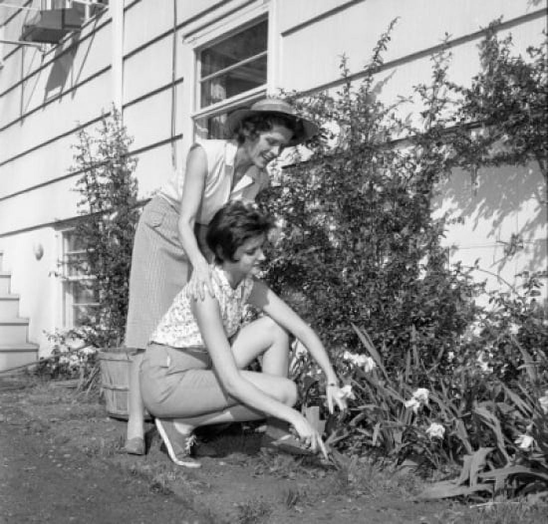Mother and adult daughter gardening outside house Canvas Art - (18 x 24)