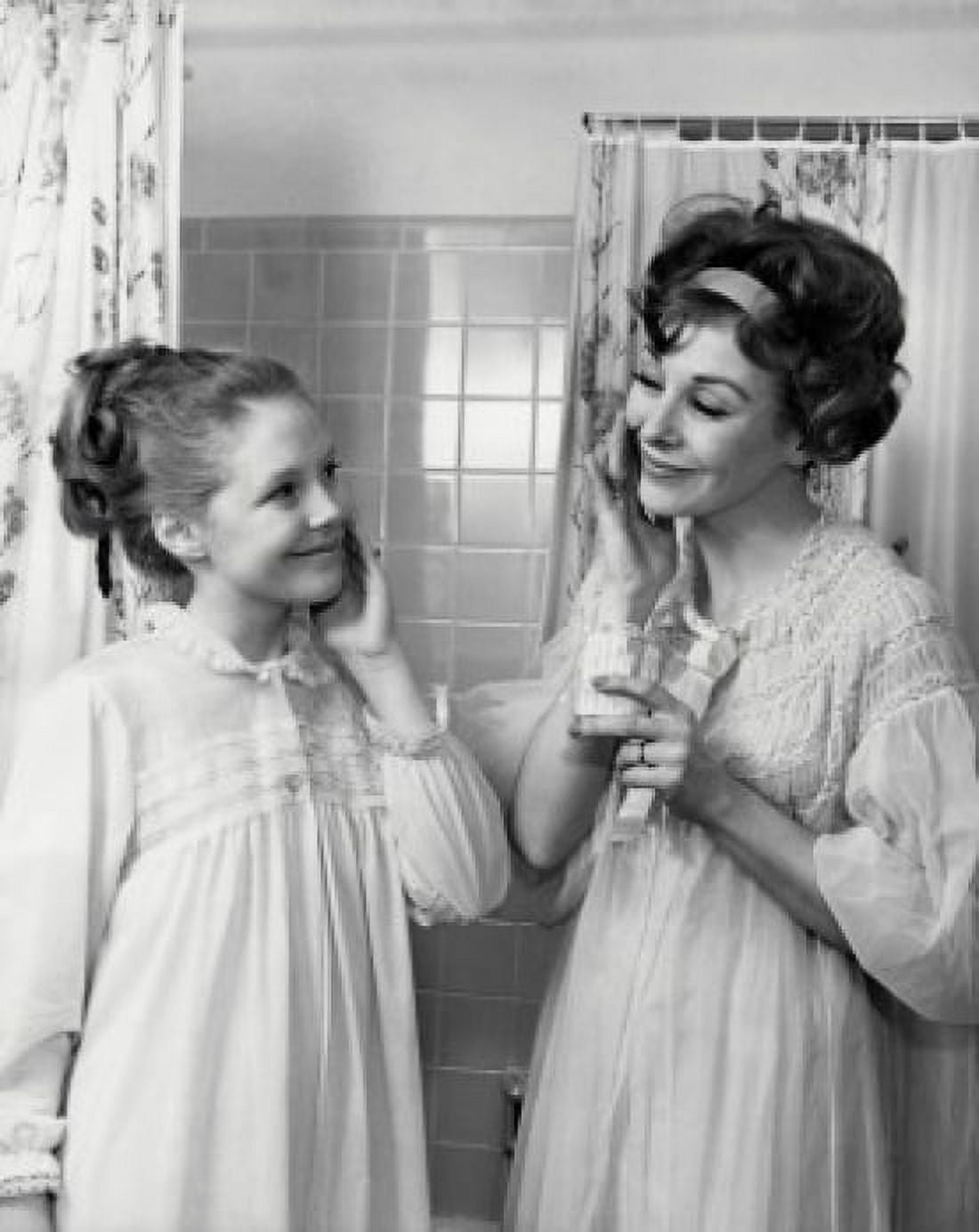 Mother and daughter applying moisturizer on their cheeks Canvas Art - (18 x 24)