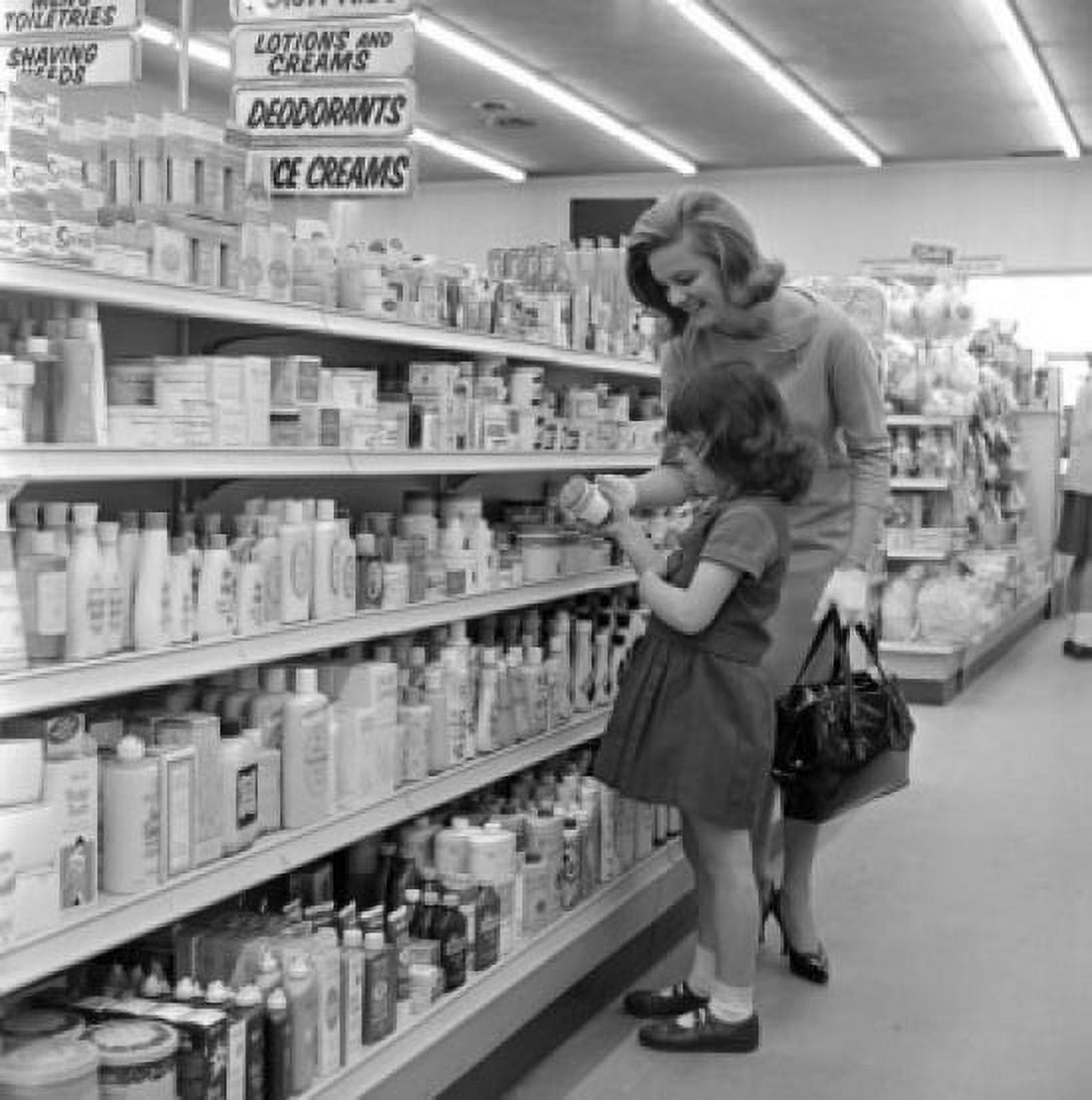Mother and daughter choosing cosmetics in supermarket Canvas Art - (24 x 36)