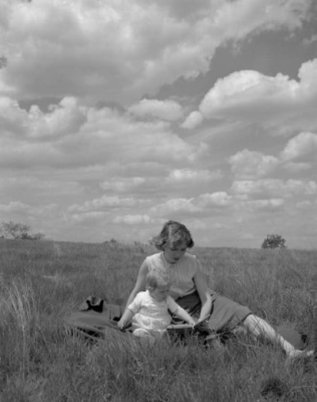 Mother and daughter sitting on meadow Canvas Art - (18 x 24)