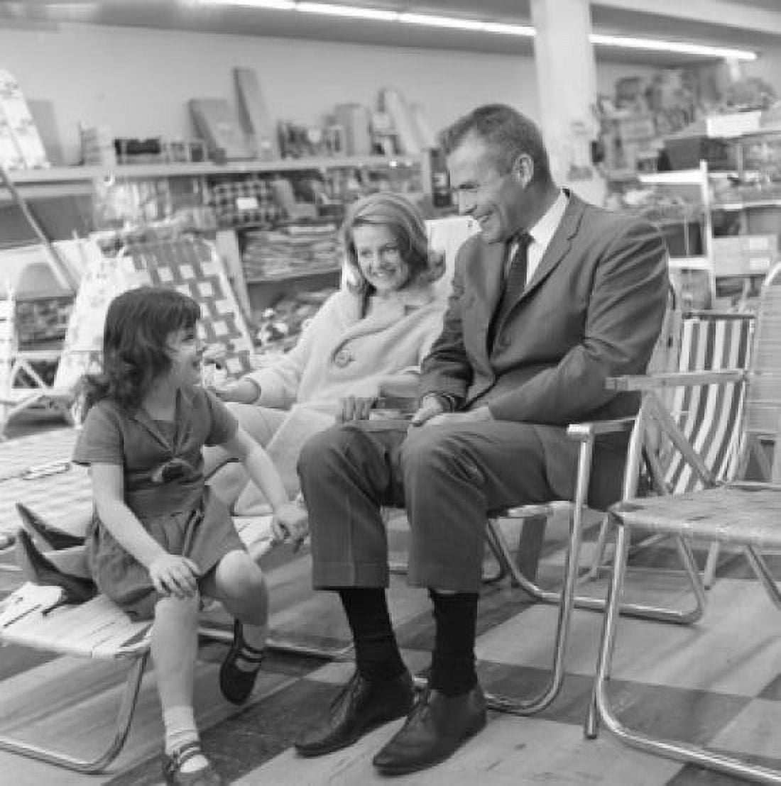 Mother and father with daughter testing deck chairs in shop Canvas Art - (18 x 24)