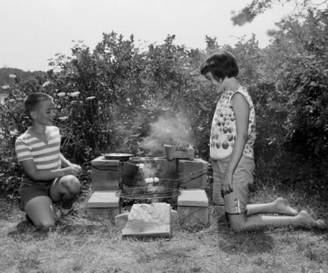Mother and son kneeling next to barbeque grill Canvas Art -  (24 x 36)