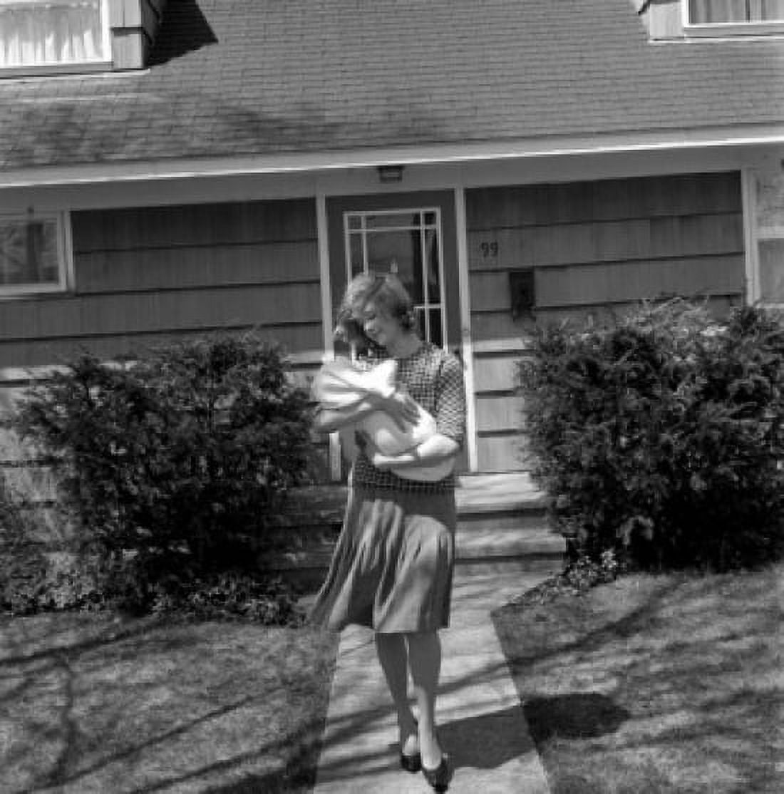 Mother carrying baby outside house Canvas Art - (18 x 24)