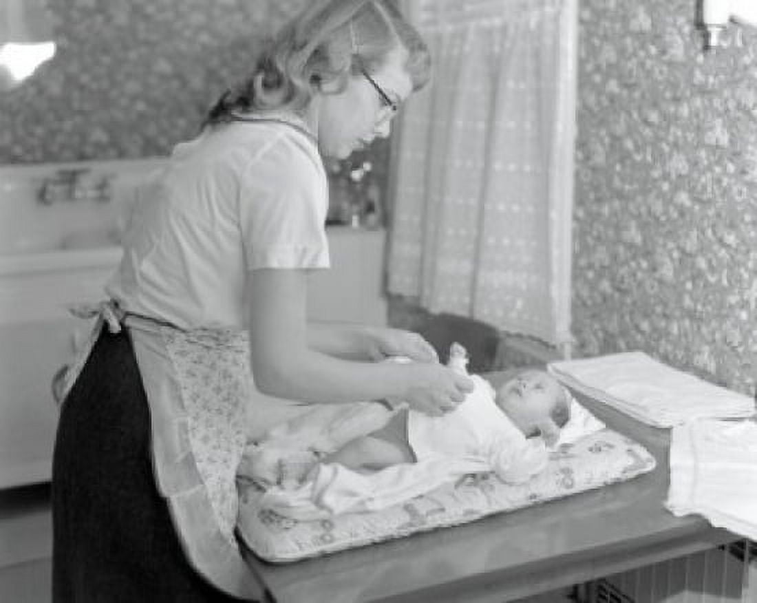 Mother changing 5 week old babys diaper Canvas Art - (18 x 24)