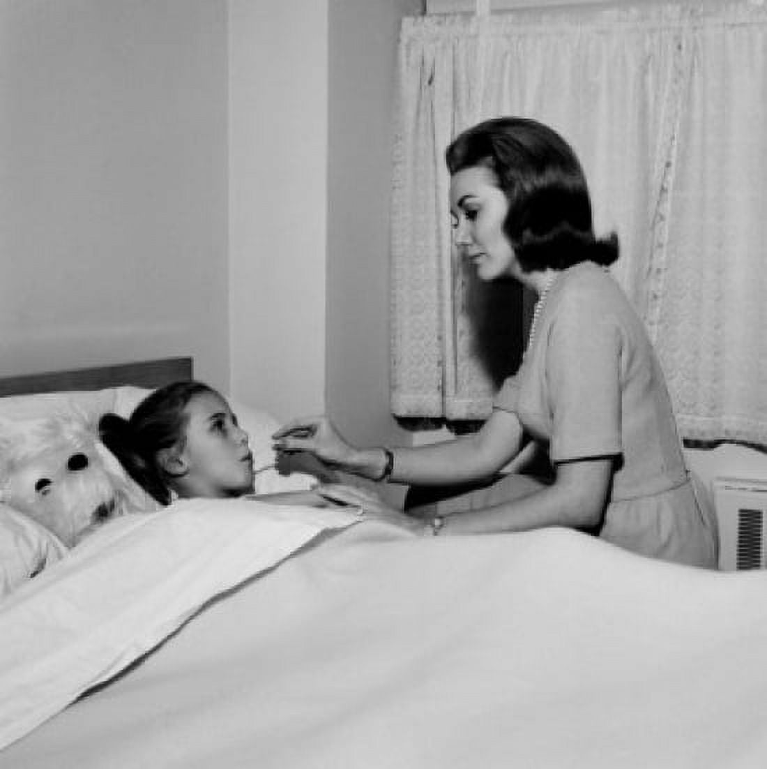 Mother checking daughters temperature in bed Canvas Art - (18 x 24)