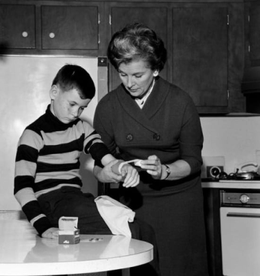 Mother dressing sons wound Canvas Art - (18 x 24)