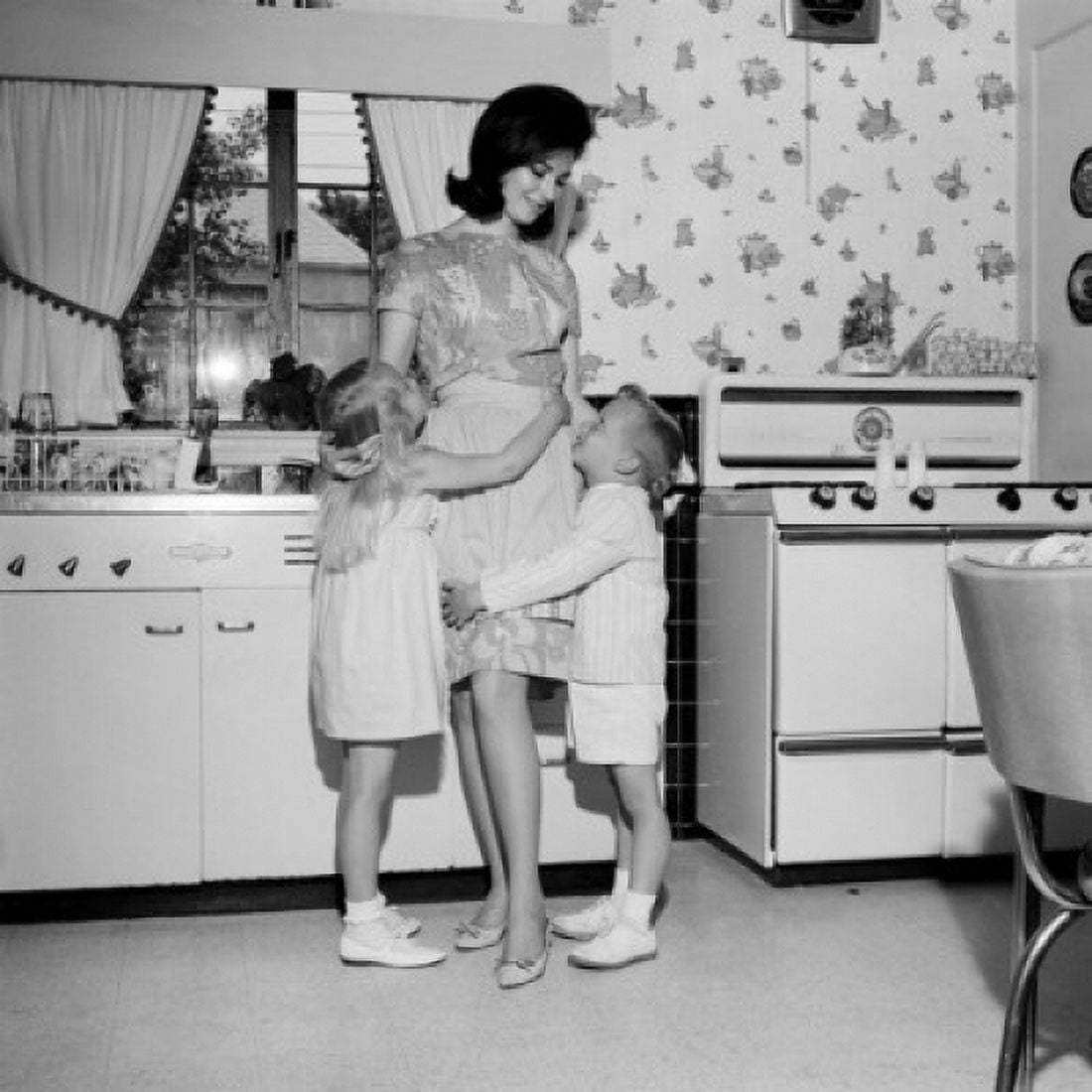 Mother embracing children in kitchen Canvas Art - (18 x 24)