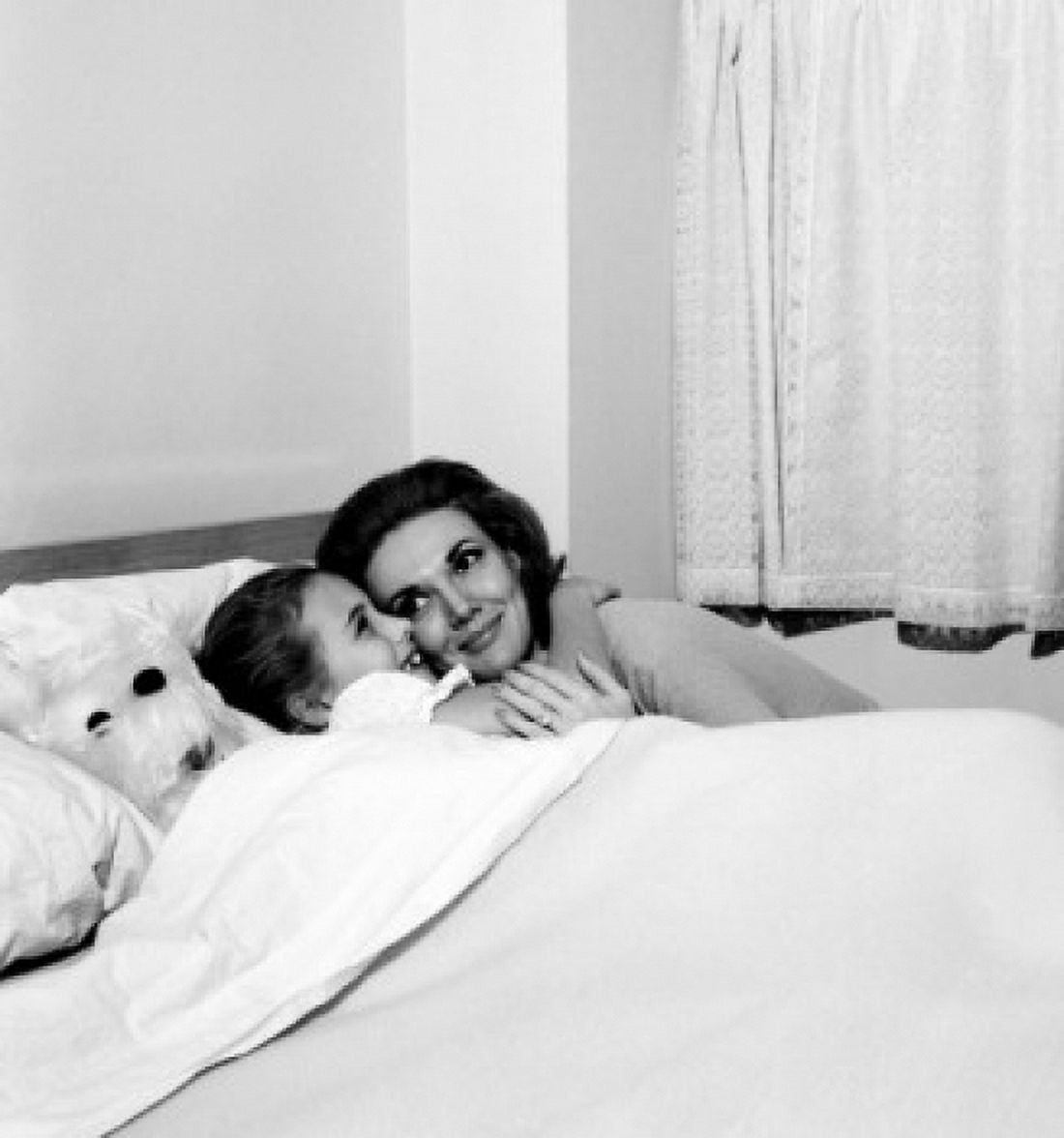 Mother embracing daughter in bed Canvas Art - (24 x 36)