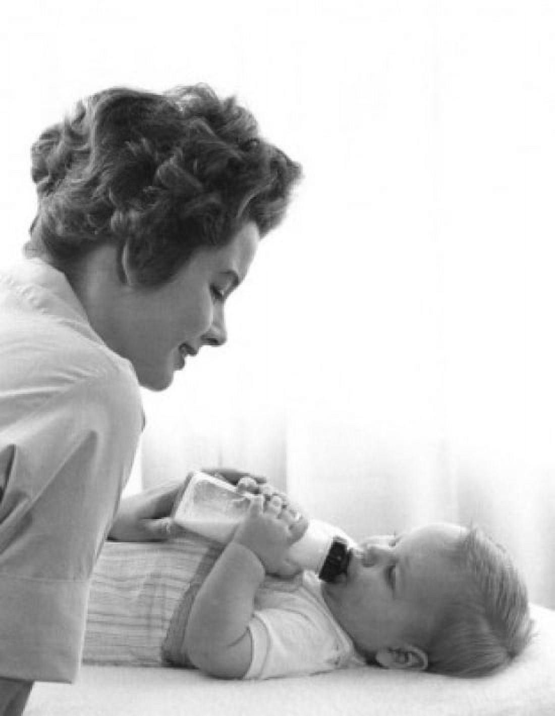 Mother feeding baby with baby bottle Canvas Art - (18 x 24)