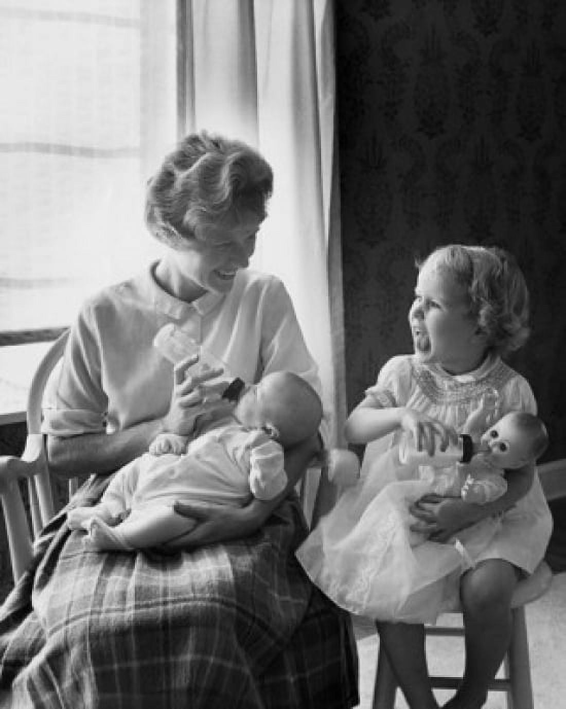 Mother feeding her baby with her daughter imitating her Canvas Art - (24 x 36)