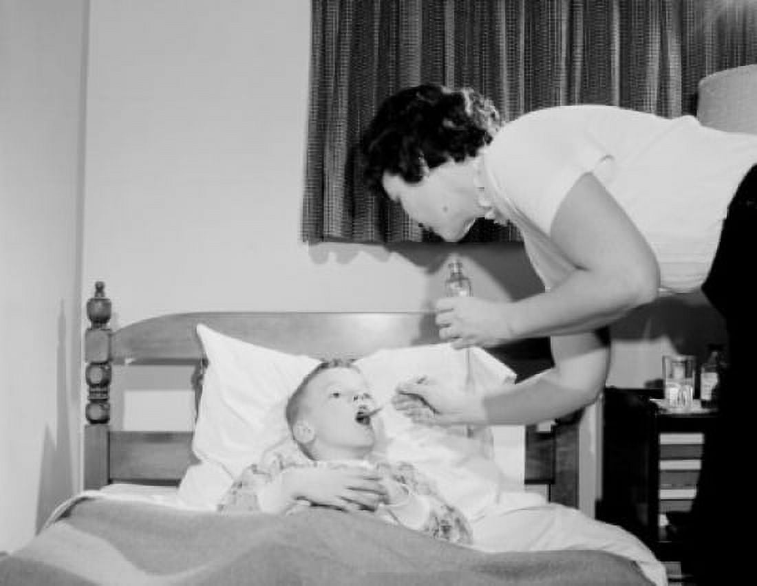Mother giving medicine to sick boy in bed Canvas Art - (24 x 36)