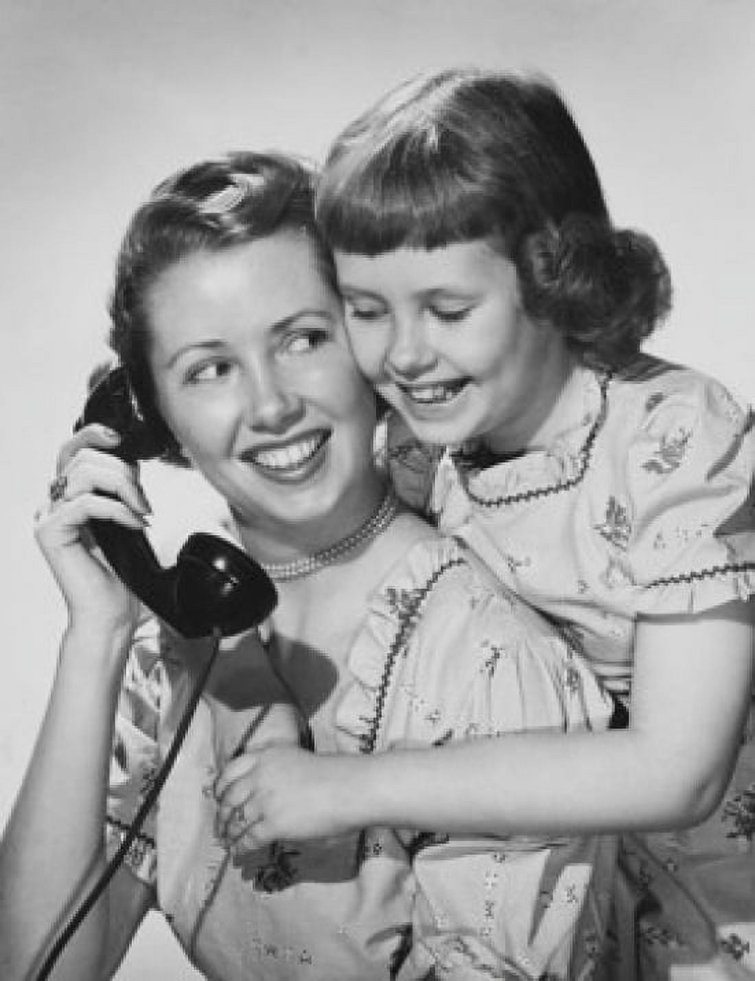 Mother holding telephone and hugging daughter Canvas Art - (18 x 24)