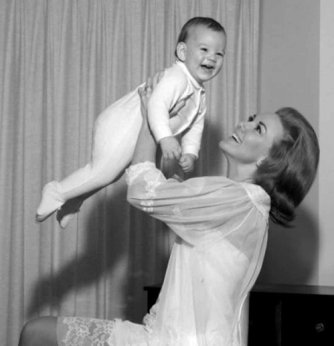 Mother lifting baby daughter high in air Canvas Art - (24 x 36)