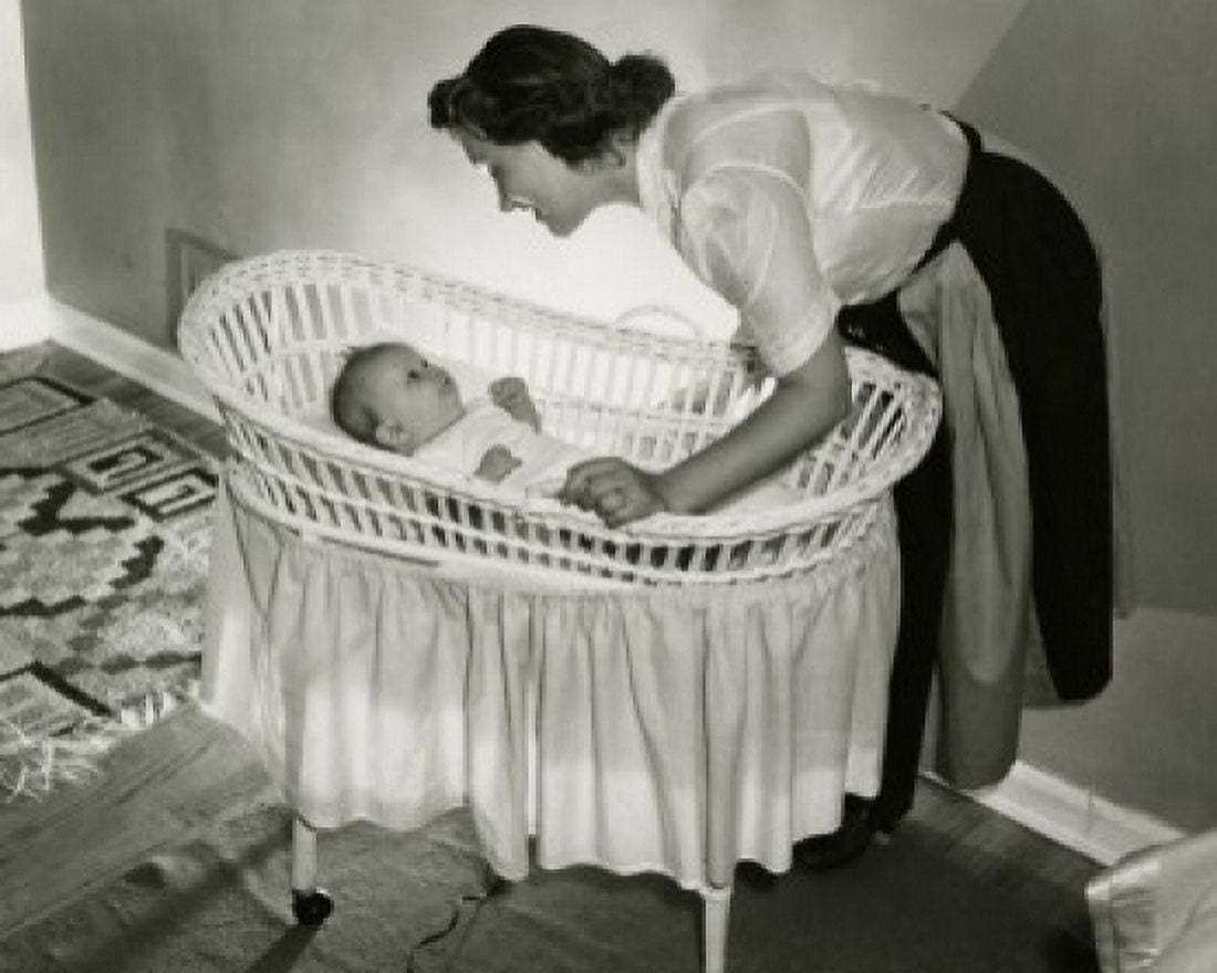 Mother looking at her baby lying in a bassinet Canvas Art - (24 x 36)