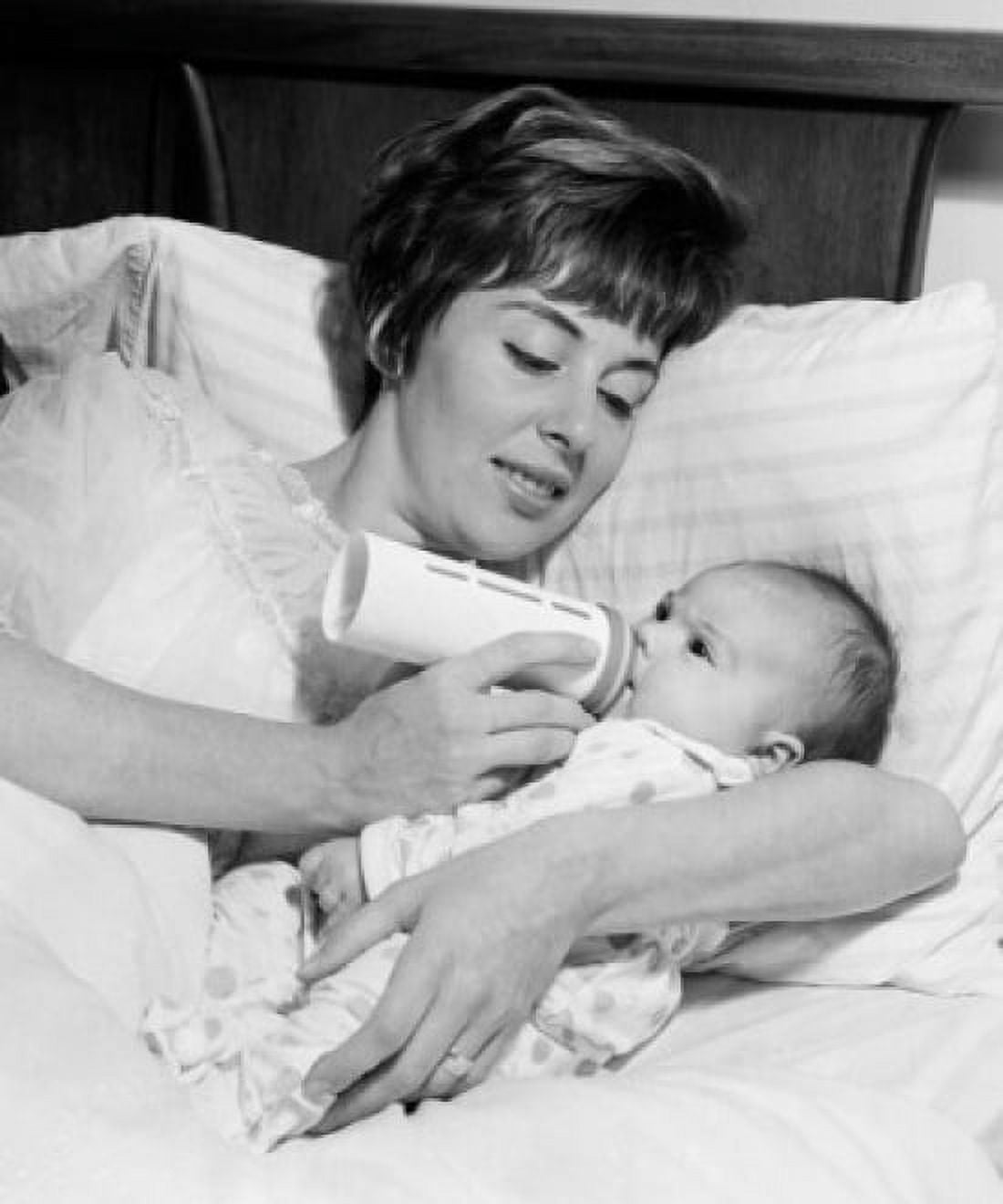 Mother lying in bed and feeding newborn baby Canvas Art - (24 x 36)