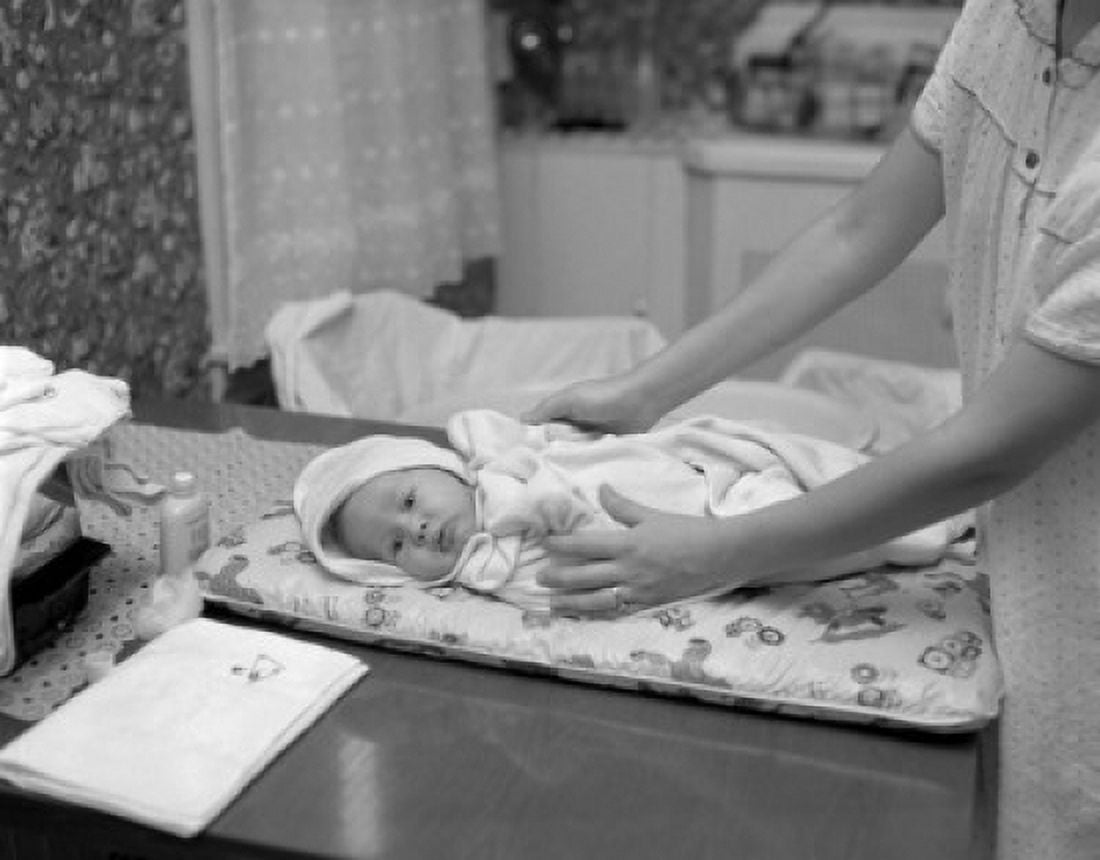 Mother nursing baby on table Canvas Art - (18 x 24)