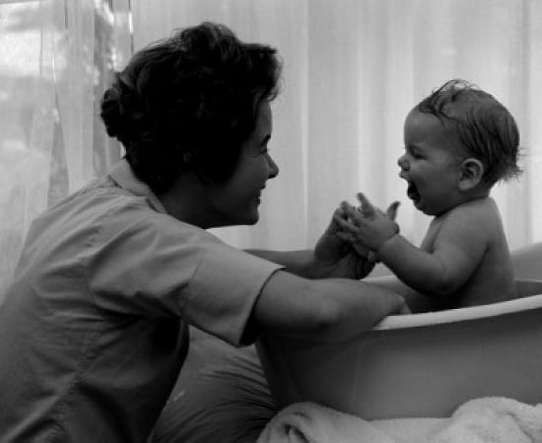 Mother playing with baby in baby bathtub Canvas Art - (24 x 36)