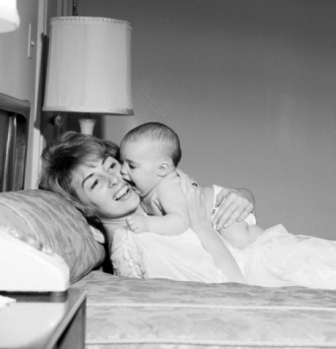Mother playing with baby on bed Canvas Art - (18 x 24)